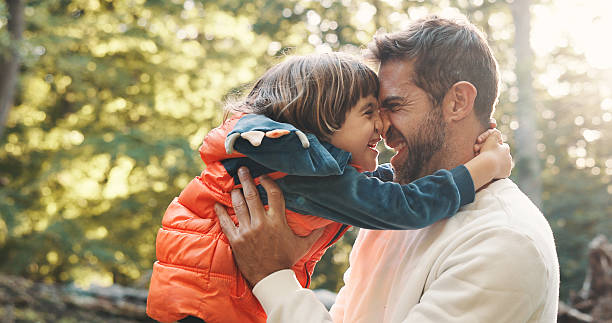 istock Nature, support and dad hugging child for bonding, connection or adventure together in park. Smile, love and father embracing boy kid outdoor with happy, family and happiness in summer with fun. 2247103697