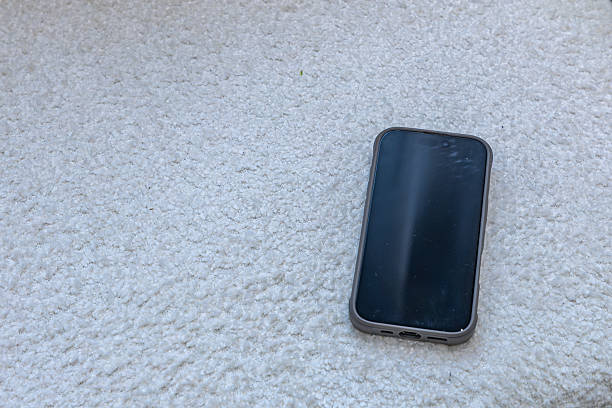 istock A company cell phone with the display turned off is placed on a white sofa, boncle 2247103786