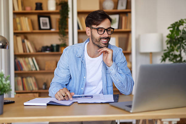 istock Happy young adult man working from his home office 2247104717