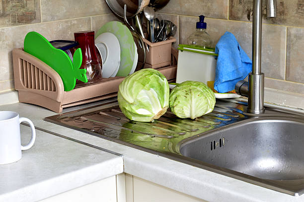 Kitchen interior. Peeled and washed cabbage heads lie on the kitchen sink.