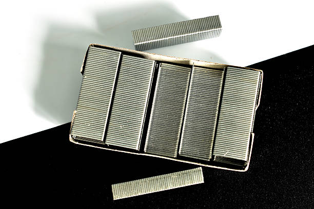 A box of paper clips for a stapler on a black and white background.