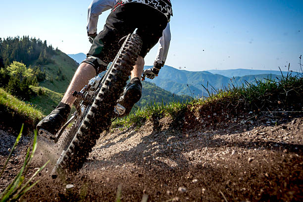 istock Male mountain biker carves turn in dust 2247106159