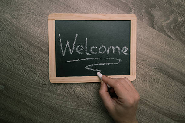 Welcome sign handwritten on the blackboard. Blackboard with text welcome