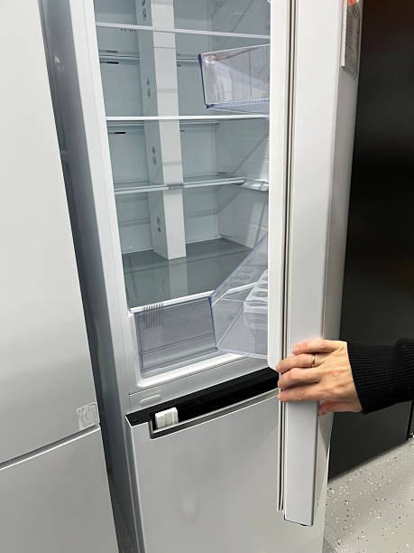 istock Modern refrigerator with open door showcasing empty shelves, highlighting sleek design and functionality, ideal for contemporary kitchen environments and home appliance displays 2247107696