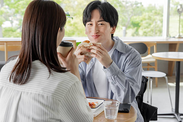 istock Asian couple enjoying lunch at a cafe 2247107981