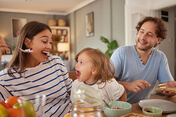 istock Happy family enjoying breakfast together at home 2247107986
