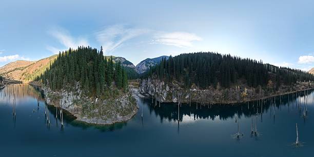 istock Serene landscape with tranquil lake and lush forested mountains 2247110747