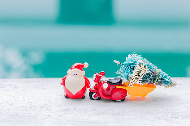 Santa with red scooter and Christmas tree over blurred background, Christmas card background idea
