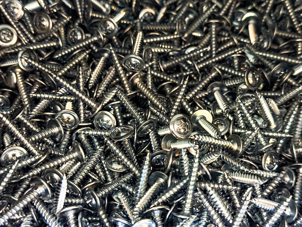 istock Silver screws with washers piled randomly. Close-up industrial texture for construction, repair or hardware store concept. 2247112105