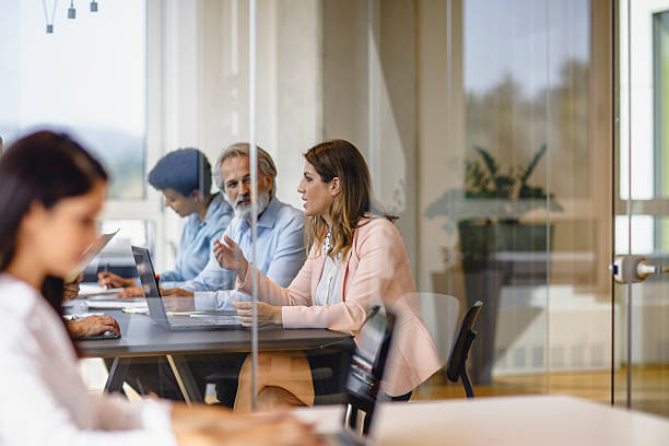 istock Business Executives Collaborating in a Modern Office Setting with Engaged Interaction 2247112925