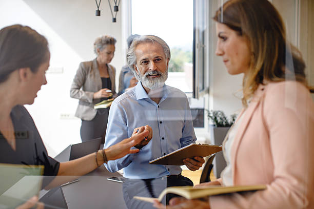 istock Engaged Business Executives Collaborating During Lively Brainstorming Session in Modern Office 2247112945