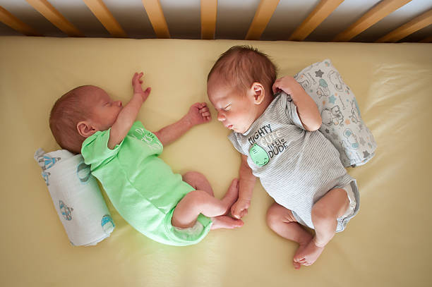 istock Twin babies sleeping peacefully in a crib, showcasing adorable expressions and matching outfits in a cozy nursery setting 2247113298