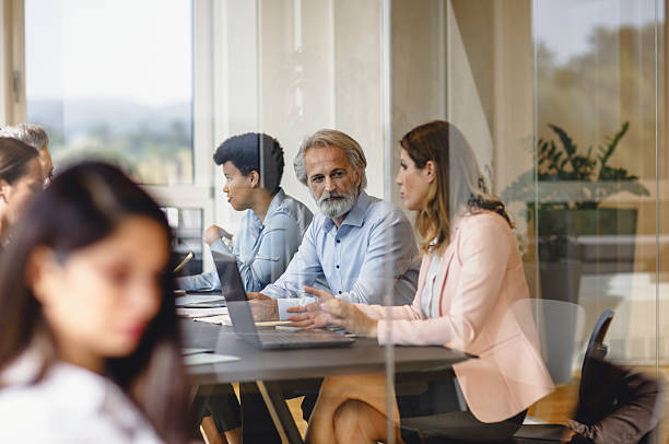 istock Diverse Business Executives Engaging in Thoughtful Collaboration in Modern Office 2247113450