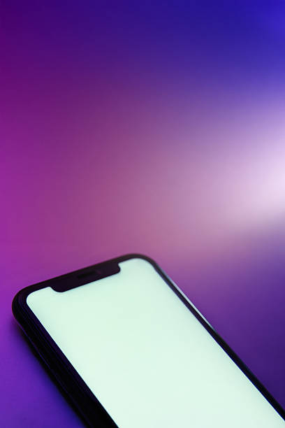 istock Smartphone with blank white screen lies on bright colorful gradient surface. 2247114056