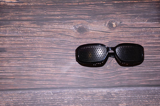 istock Glasses with perforation. Glasses for vision with holes. Perforated training glasses. Glasses with holes for improved vision. 2247114196