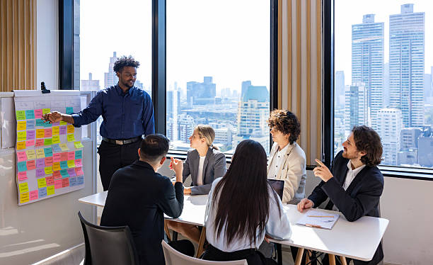 istock African manager is presenting new project to team in the executive meeting for next year plan with market share increase for global business and investment 2247114748