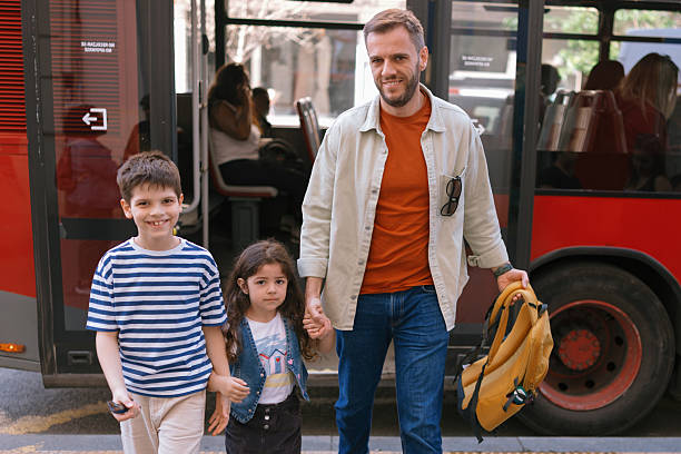 istock Dad and kids disembarking from bus 2247115727