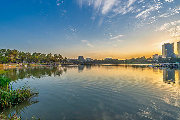 istock Sunset scenery by the city lake 2247117043