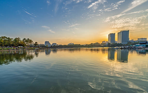 istock Sunset scenery by the city lake 2247117044
