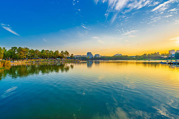 istock Sunset scenery by the city lake 2247117052