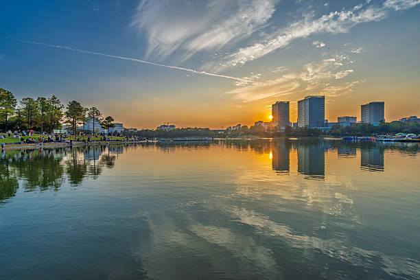 istock Sunset scenery by the city lake 2247117088