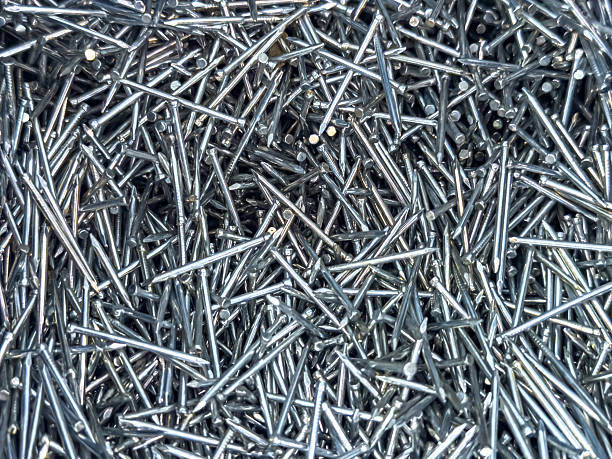 istock Close-up of shiny silver nails scattered randomly. Metallic texture suitable for backgrounds, construction, DIY 2247117722