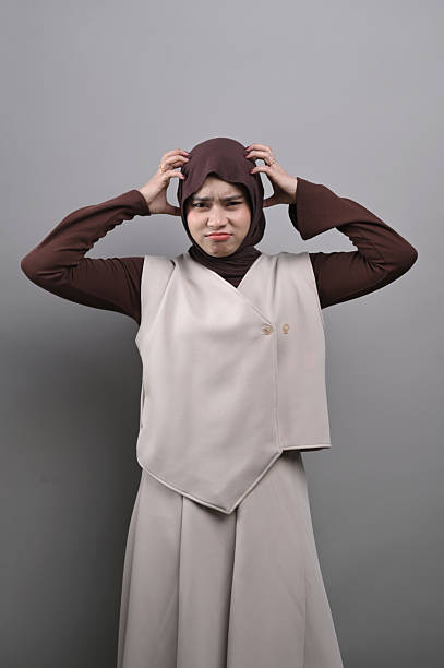 istock Studio Shoot Asian hijab girl showing stress gesture with hand on head 2247120700