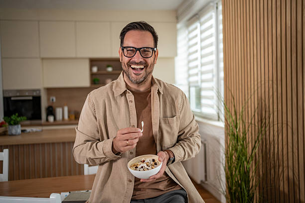 istock Happy man enjoying healthy breakfast cereal in kitchen 2247124226