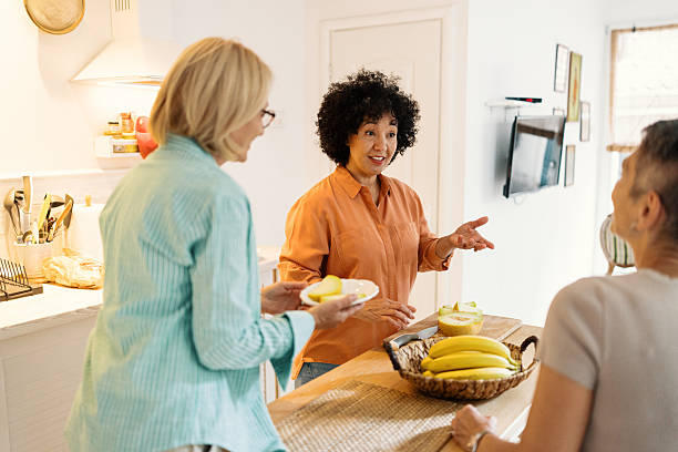 istock Three Women Preparing Brunch and Chatting in a Cozy Kitchen 2247125217