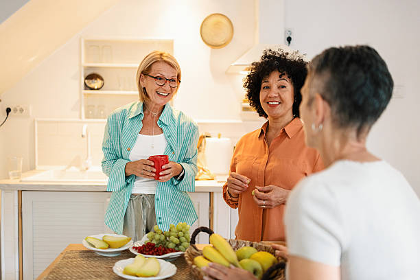 istock Women Chatting and Eating Fruit at Brunch 2247125254
