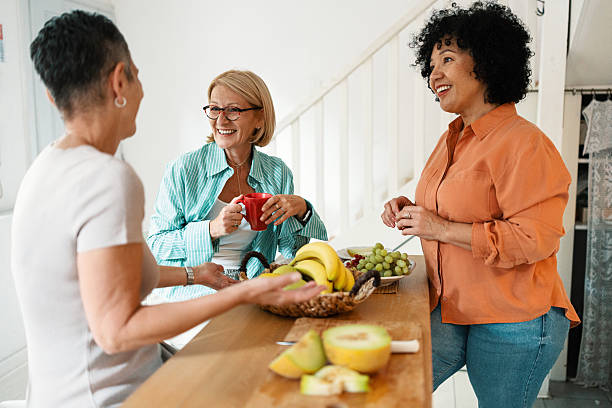 istock Mature Friends Enjoying Fruit During Brunch at Home 2247125279