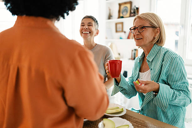 istock Mature Friends Enjoying Fruit During Brunch at Home 2247125304