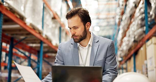 istock Warehouse, paperwork and man on laptop for supply chain, online inspection and shipment inventory. Distribution, storage depot and person on computer for logistics, shipping and delivery checklist 2247125571