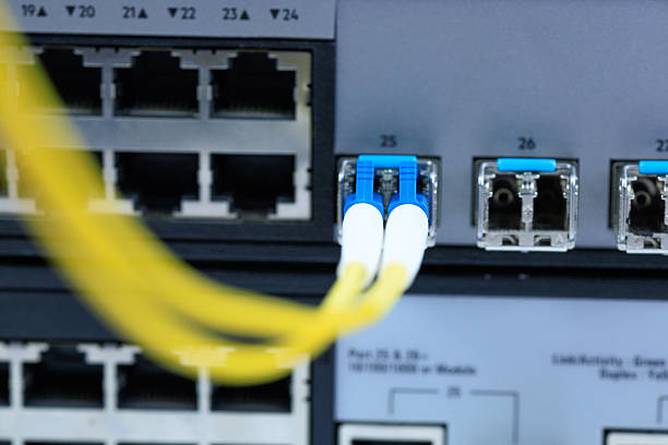 istock Yellow coiled fiber optic patch cord with blue connectors SFP modules are essential for high-speed data transmission over fiber optic networks. 2247126784