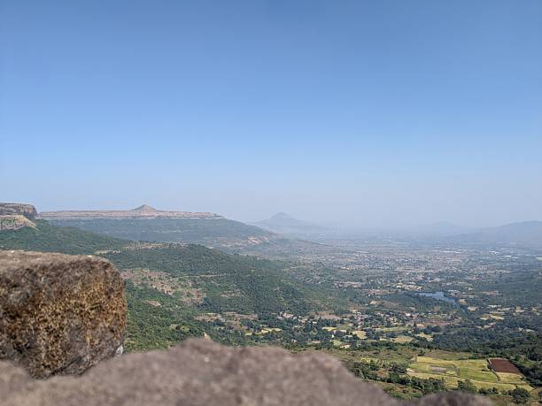 istock Breathtaking view from a mountain summit overlooking verdant valleys and distant peaks under a clear blue sky 2247128221