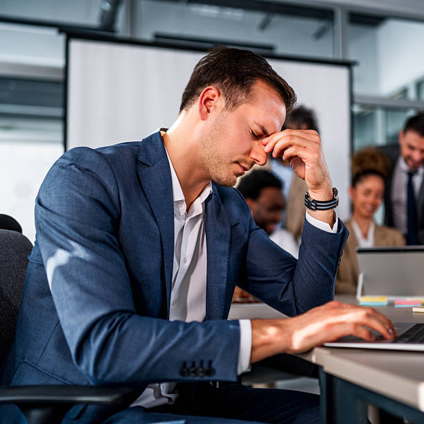 istock Businessman feeling stress and headache during office meeting 2247129127
