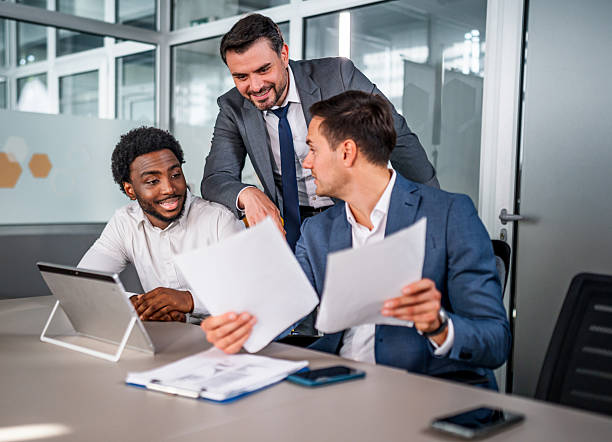 istock Businessmen collaborating during meeting in modern office 2247129206