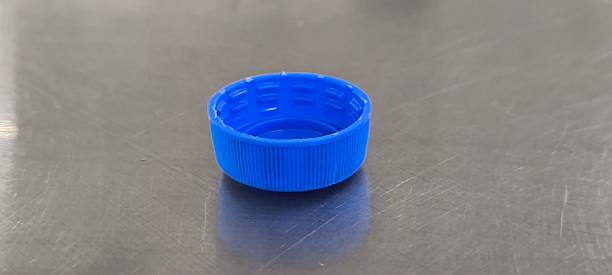 istock A blue soda bottle cap sits on a stainless steel table. 2247129822