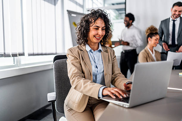 istock Businesswoman working on laptop during office meeting 2247129966