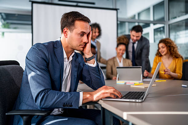 istock Stressed young businessman experiencing burnout during office meeting 2247131173