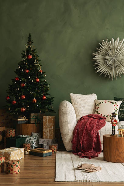 istock Elegant Christmas interior with a decorated tree, wrapped presents, and a white sofa with festive pillows and a red throw. 2247132829