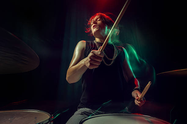 istock Rock drummer illuminated by neon lights captured with expressive motion blur 2247133003