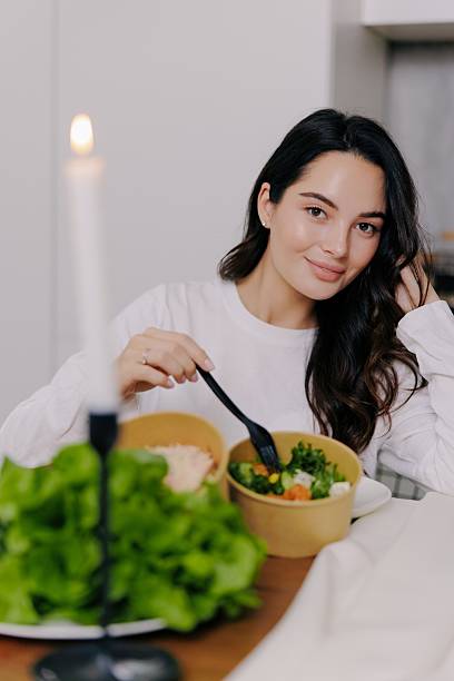istock Happy Woman Eating Healthy Salad Dinner 2247133763