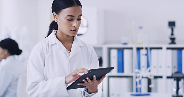 istock Science, woman or reading with tablet in research lab, study biotech innovation or medical development. Healthcare advancement, trial results and scientist check pharma test, tech and medicine report 2247133979