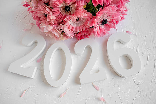 istock Year 2026 with pink anemone flowers and petals 2247135357