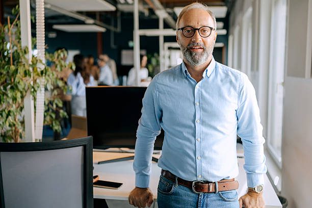 istock Well dressed mature businessman posing for camera at the office 2247136306