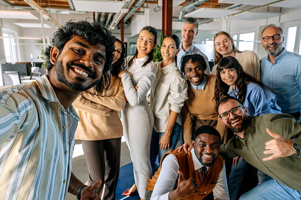 istock Group of diverse colleagues taking selfie at office 2247136551
