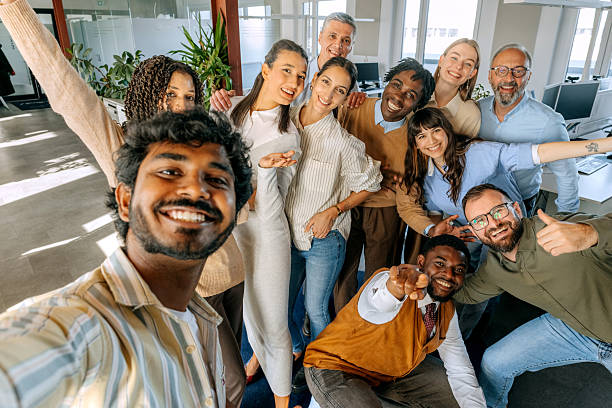 istock Group of diverse colleagues taking selfie at office 2247136559