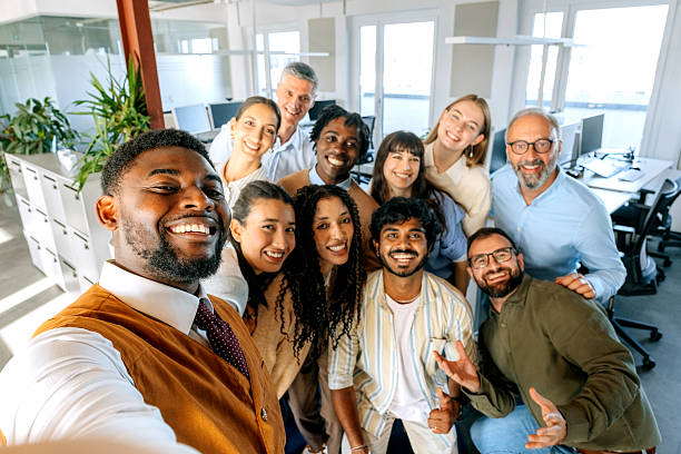 istock Group of diverse colleagues taking selfie at office 2247136561