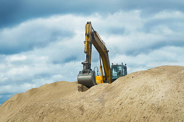 istock creative background. a tracked excavator is working in a sand quarry 2247137261